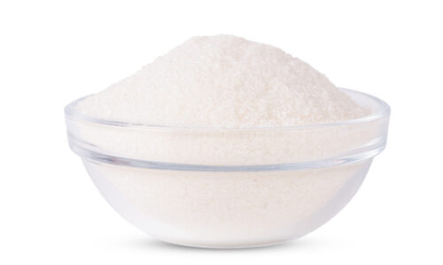 Sugar in glass bowl isolated on white